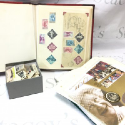 A world stamp album containing stamps from Malta, Hong Kong, Churchman , Players cigarette cards