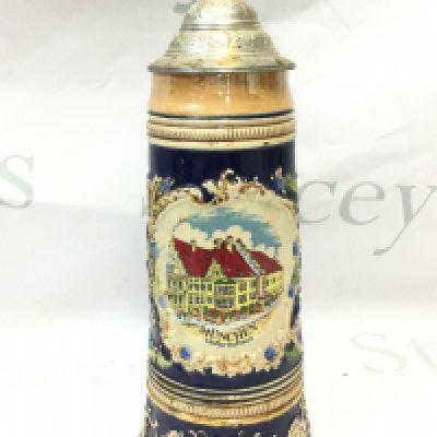 A German musical Porcelain tankard with painted design of famous Beer Hall, Muchnen Hofbrauhaus. 29cm tall