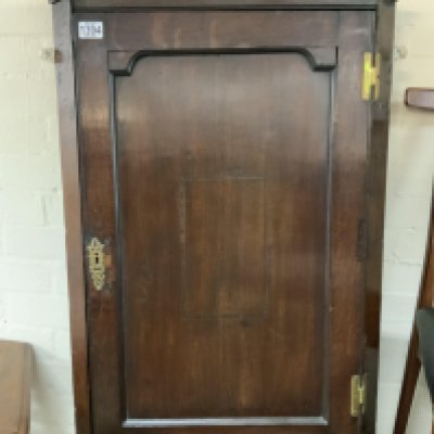 An Early George III oak corner cabinet.