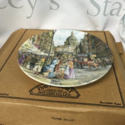 A collection of vintage plates including the flower seller by Brian Eden