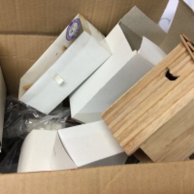 A box of items including parts of Streets Ahead Dollhouse.