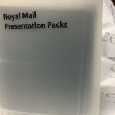 A collection of stamp related items including an empty Royal Mail Presentation Pack, used world stamps and loose first day covers.