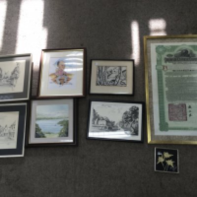 A small collection of pictures and a framed Imperial Chinese bond.