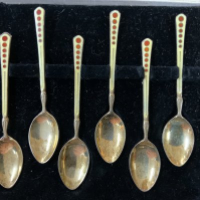A Cased set of hallmarked silver gilt and enamel coffee spoons. (A)