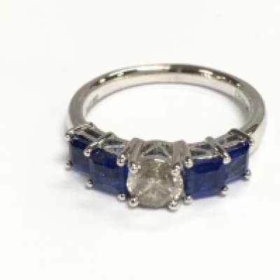 A platinum 5 stone ring set with central diamond flanked by Princess cut sapphires. Diamonds 0.53ct and sapphires 1.45ct. Size N