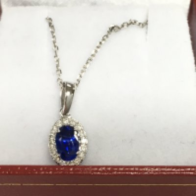 18ct white gold sapphire and diamond cluster pendant on an 18ct white gold chain. Sapphire 0.59ct and diamonds 0.10ct.