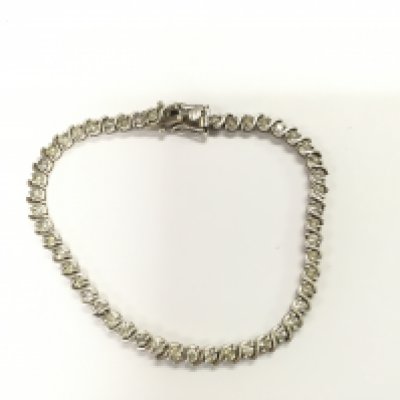 A silver line bracelet set with diamonds with twist style links. Approximately 6.50ct.