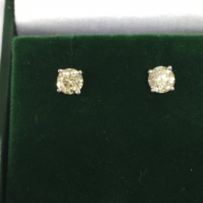 A pair of 18ct white gold diamond solitaire studs. Approx 0.82ct. Postage B
