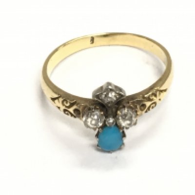 An unmarked gold ring set with turquoise and diamonds. Size P and 3.40g