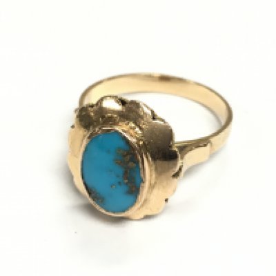 An unmarked gold ring set with turquoise. 3.61g and size O