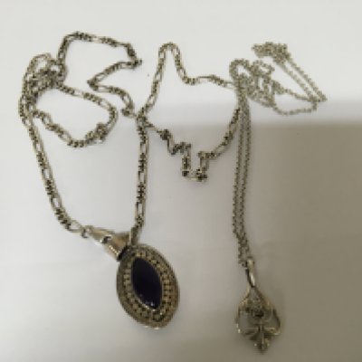 Two Silver necklaces one with a polished amethyst and one other floral pendent both on silver chains. (2) NO RESERVE