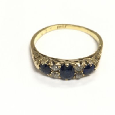 An 18ct gold ring set with a sapphire and diamonds. 3.13g and size Q