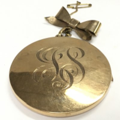 A gold plated large locket , 5cm wide. Postage category A