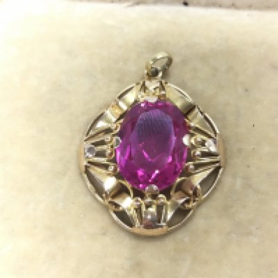 A pink stone pendant . Postage category A