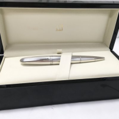 An Alfred Dunhill silver torpedo dual pen and cigar puncher.
