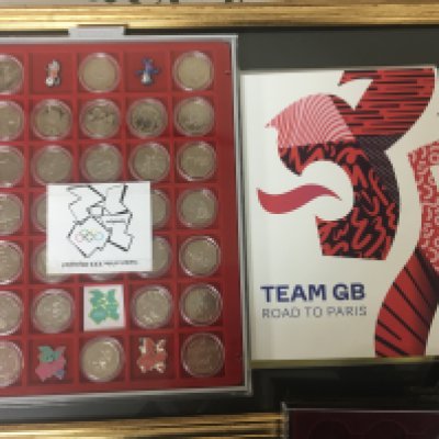 A collection of Olympic commemorative coinage Team GB road to Paris fifty pence London Olympic coins framed stamps and cases of other commemorative coins.
