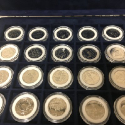 Three cased sets of American coins Platinum plated 50 state Quarter set Presidents Gold Plated Dollar set and one other gold plated 50 state Quarter sets. (3)