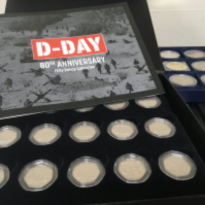 A collection of cased coins The D-Day 80th Anniversary fifty pence set my Great Britain A-Z of World War Two and a Royal Mint 2023 set. (4)