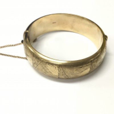 A 9ct gold hollow bangle decorated with swans. Approx weight 31.02 grams