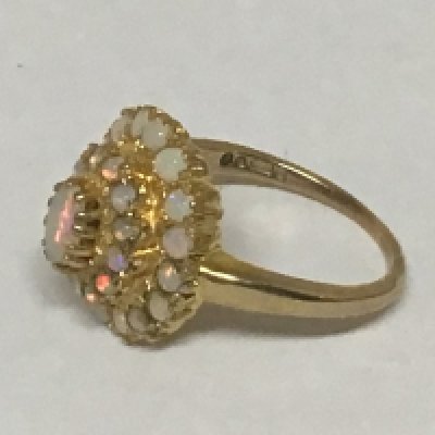 A 9carat gold ring set with a pattern of opals.