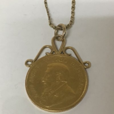 A Gold South African one pound coin 1897 on a pendent mount with attached 9Carat gold chain. Total weight 12.5g