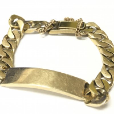 A 9ct gold heavy I.D bracelet with safety chain. Appox weight 61.43 grams.