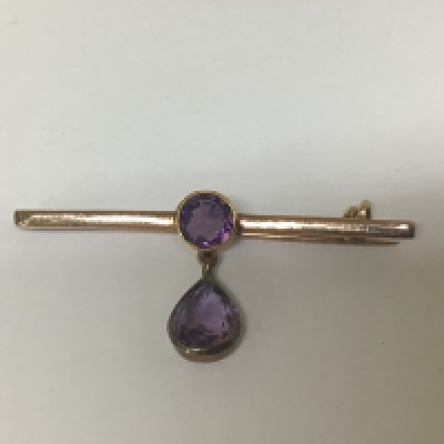An unmarked brooch set with two Amethyst stones weight 3g