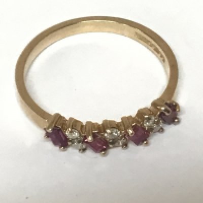 A 9carat gold ring set with alternating rows of baguette ruby and small brilliant cut diamonds.ring size P weight 2g