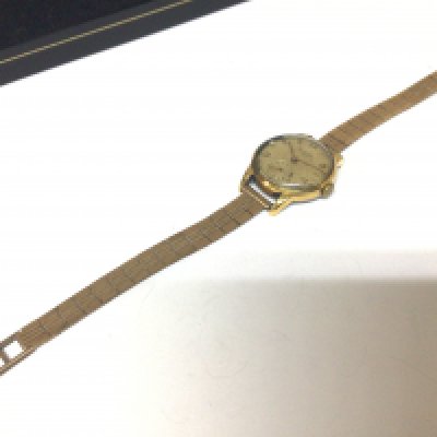 A Vintage ladies watch maker Levrette the watch with a steel back with a 9carat gold attached bracelet