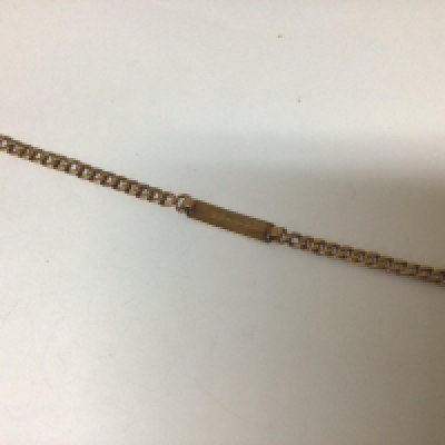 A gold ID bracelet possibly 18carat gold the attached enamel charm marked 750 sold as seen buyer to satisfy themselves before they bid. Weight 7g