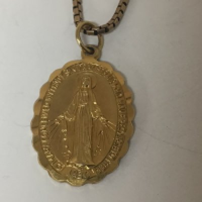A 9carat gold religious themed pendent depicting the holly mother with attached 9ct gold chain weight 8g