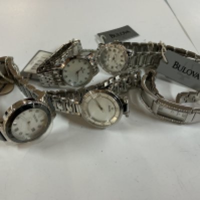 five ladies bulova watches some with tags.