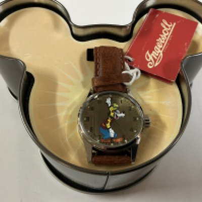 a Disney goofy ingersoll watch on a leather strap.