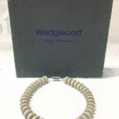 A boxed Wendy Ramshaw (1939-2018) necklace with Wedgwood hand turned beads ,a silver clasp hallmarked maker J.W and signed WR. 13cm wide approximately . Postage category B