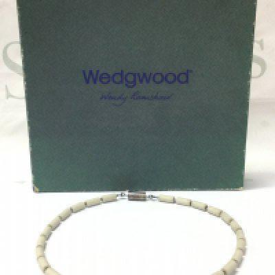 A boxed Wendy Ramshaw (1939-2018) necklace with Wedgwood hand turned beads ,a silver clasp hallmarked maker J.W and signed WR. 14cm wide approximately . Postage category B