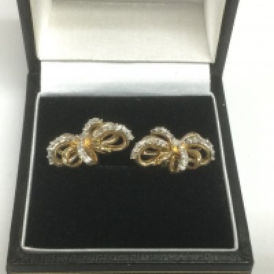A pair of 10k gold and diamond bow earrings, approx 3.7g. Shipping category A.