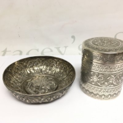 withdrawn - An embossed silver bowl of Indian influence depicting St George and the dragon to the centre, approx diameter 12.5cm plus a silver jar and cover, some damage. Shipping category B.