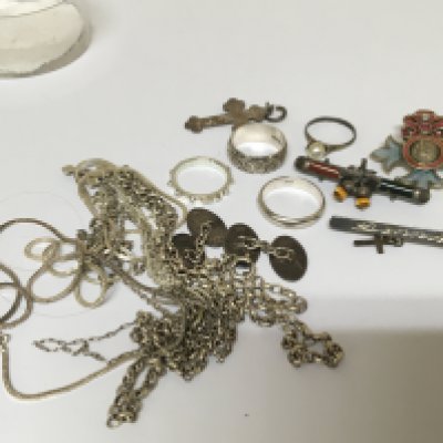 A collection of silver jewellery rings necklaces cufflinks an enamel badge For God and the Empire