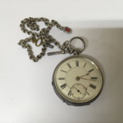 A silver cased Key wind Waltham Pocket watch with attached silver watch chain and white enamel dial.