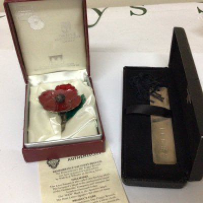 A silver and enamel Remembrance Day Poppy and a silver book mark both in presentation boxes, (2)
