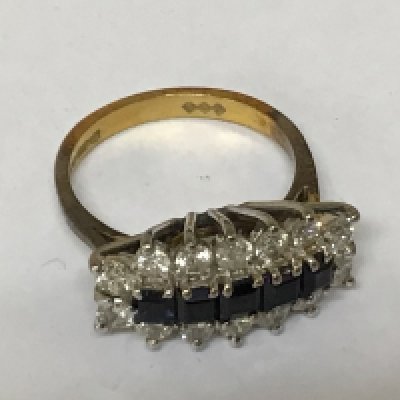 An 18carat gold ring set with a row of sapphire flanked by diamonds.weight 4g