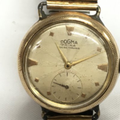 A vintage 9ct gold cased Dogma Prima watch. Winds and runs. Case approx 36mm