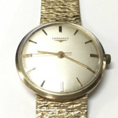 A gents Longines watch with a 9ct gold case and strap. Approx weight 64.55 grams.