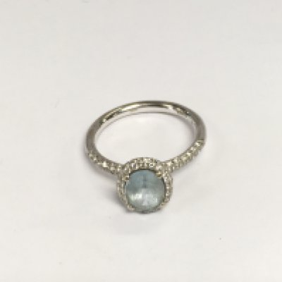 An 18ct white gold ring set with a central aquamarine flanked by diamonds, approx 5.4g and approx size R-S. Shipping category A.