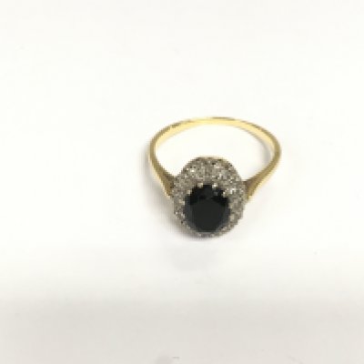 A gold ring set with a central sapphire surrounded by diamonds, approx 3.8g and approx size Q. Shipping category A.