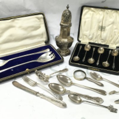 Silver hallmarked items including a Sugar sifter, Cased coffee spoons , Cased salad servers, magnifying glass etc . Postage cat b