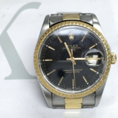 A Rolex oyster perpetual date. Gold and steel two tone watch. Black dial. Case Approx 36mm. Seen running. Watch would benefit from clean and service.
