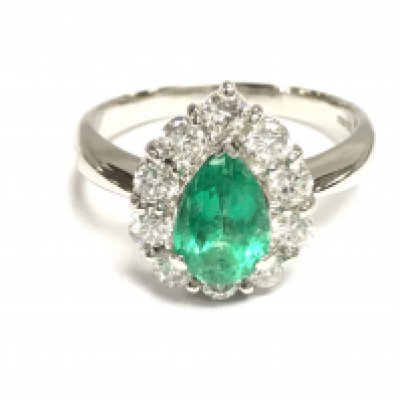 A platinum ring set with a pear shaped emerald with a border of diamonds. Emerald 1.12ct and 0.82ct diamonds approx. Size P 1/2