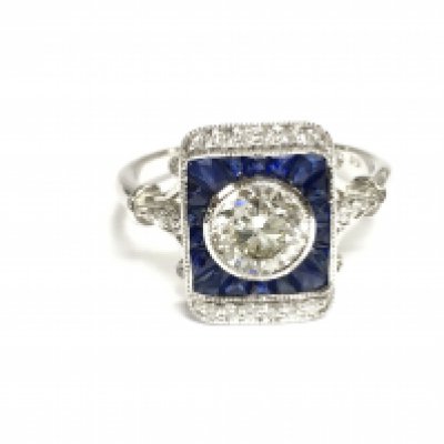 18ct white gold target style ring set with central diamond surrounded by mixed cut sapphires and further diamonds. Central diamond is 1.01ct. Size N 1/2