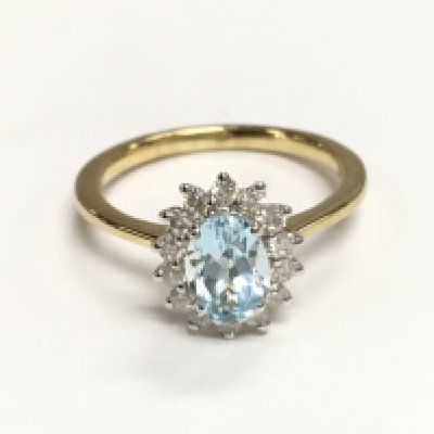 9ct yellow and white gold oval cut blue topaz and diamond cluster ring. Topaz 0.94ct and diamonds 0.24ct approximately. Size M